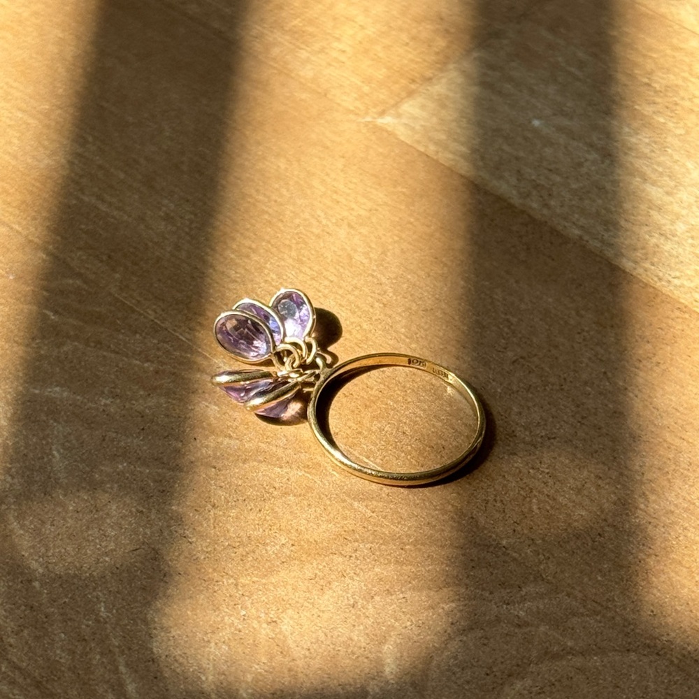 10k yellow gold ring with dangling oval cut purple stones